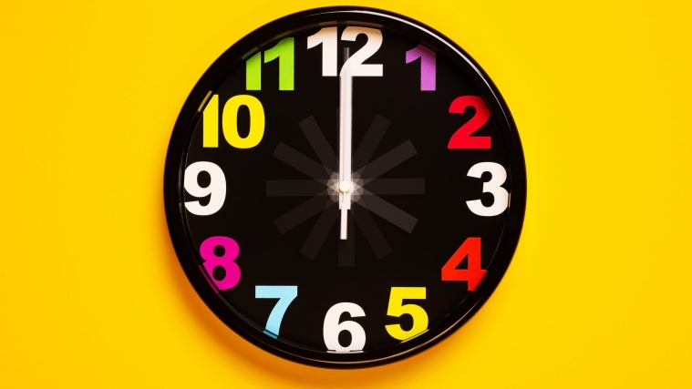 black and yellow analog clock